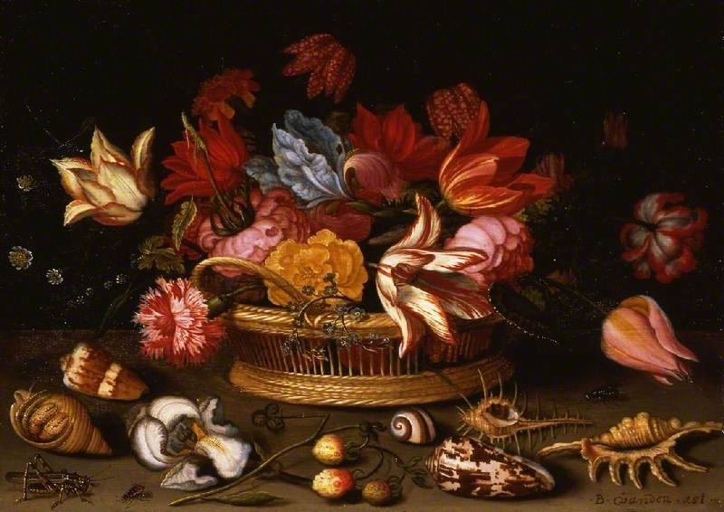 A basket of flowers with shells on a ledge