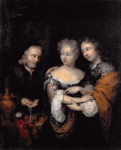 Old man offering a necklace to a young couple