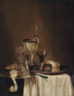 Still life of blackberry pie, pewter platter, roemer, tazza, lemon, olives and a nautilus cup