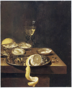 Still life of peeled lemon with chestnuts on a pewter dish, with oysters, wine glass and another lemon