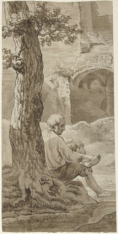 Man onder een boom bij een watertje