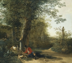 Peasant playing with his dog while resting at the margin of a wood by Adam Pynacker