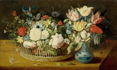 Still life with flowers in a woven basket and a floral bouquet in a porcelain vase on a table top with insects