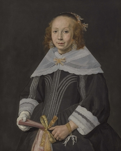 Portrait of a young woman holding a fan