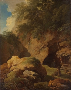 Paysage et rochers, un ermite se repose à l'entrée d'une grotte
