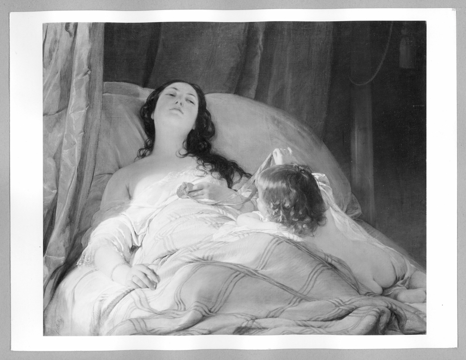 young woman in bed, playing with child