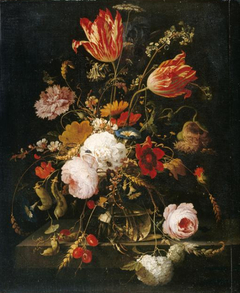 Flowers in a glass vase on a stone ledge