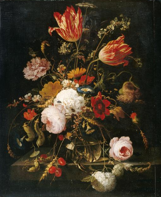 Flowers in a glass vase on a stone ledge