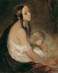 Mutter mit Kind unter dem Kruzifix