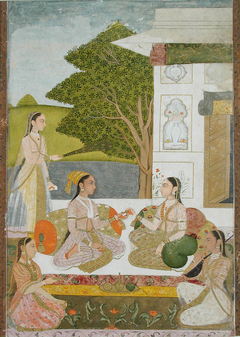 Two women and musicians seated outside a pavilion