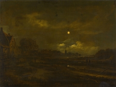 A moonlit river landscape with a village, a windmill and church beyond, with travellers on a path in the foreground by Aert van der Neer