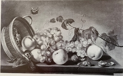 Still life of an upturned basket of fruit
