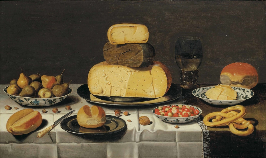 Laid table with cheese, bread, fruit and a roemer
