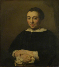 Portrait of a Young Woman with her Hands Folded on a Book by Willem Drost