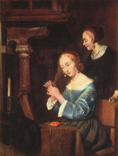 A Lady dressing her Hair