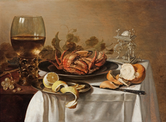 A still life with a roemer, a crab and a peeled lemon