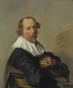 Portrait of a man leaning over the back of a chair