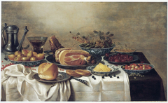 Still life of food on a table by Floris van Schooten