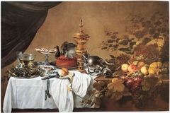 Still life with gilt covered beaker, fallen decanter, turkey pie, tazza, silver platter with berkemeyers and fruit by Pieter Claesz
